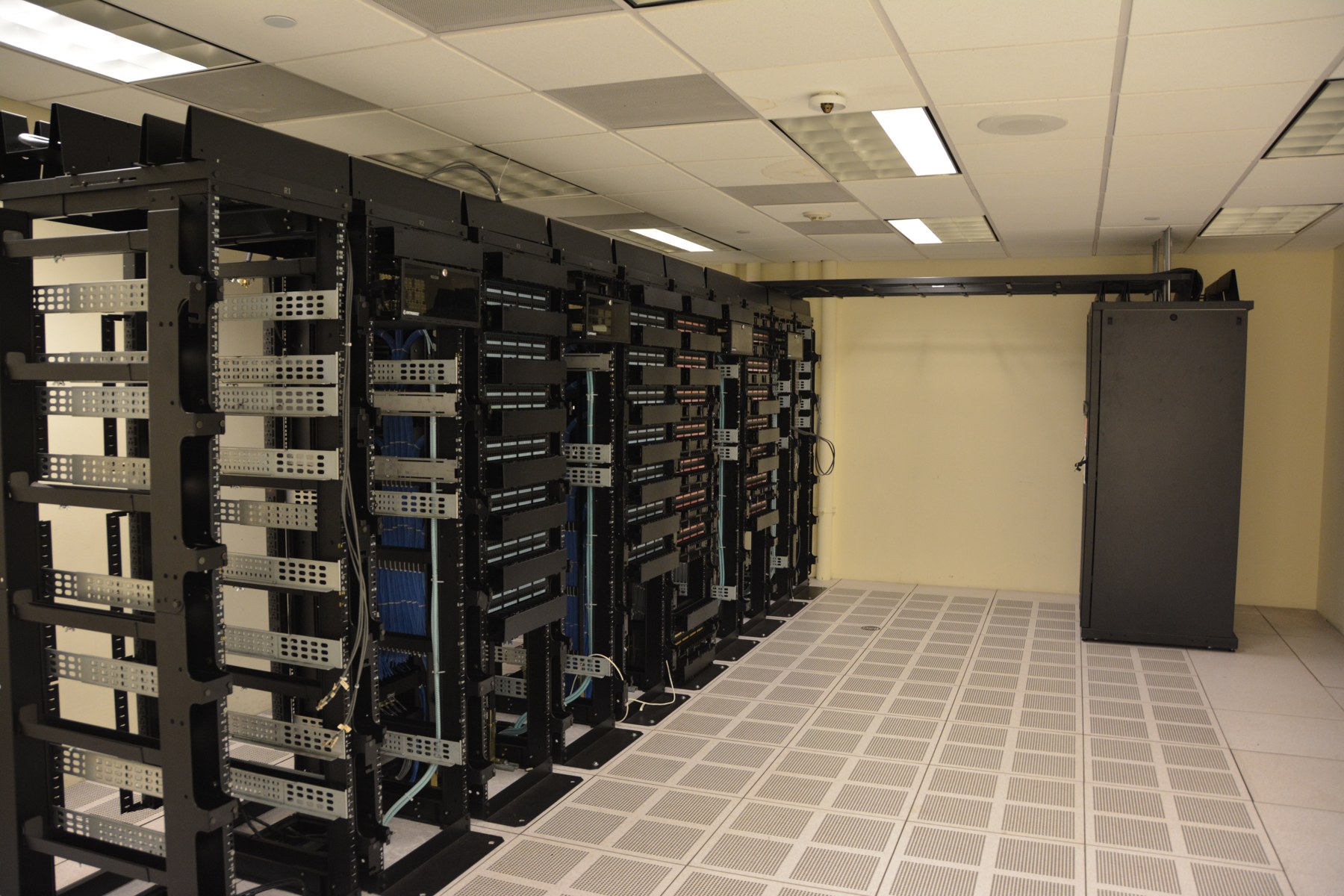 Server racks in a data center. Contextual file photograph; not an OpenAI facility.